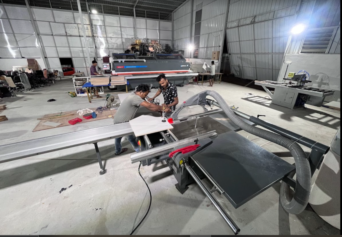 aarya interio employees working on panel saw machine
